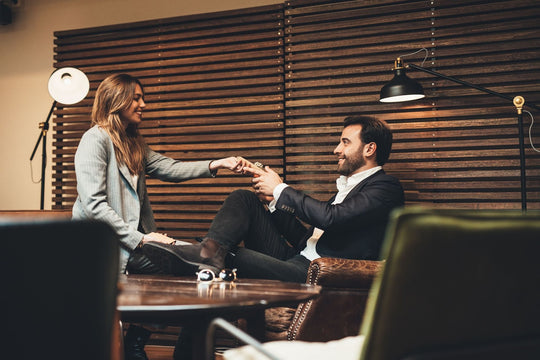 woman handing a man a smart wallet as a gift